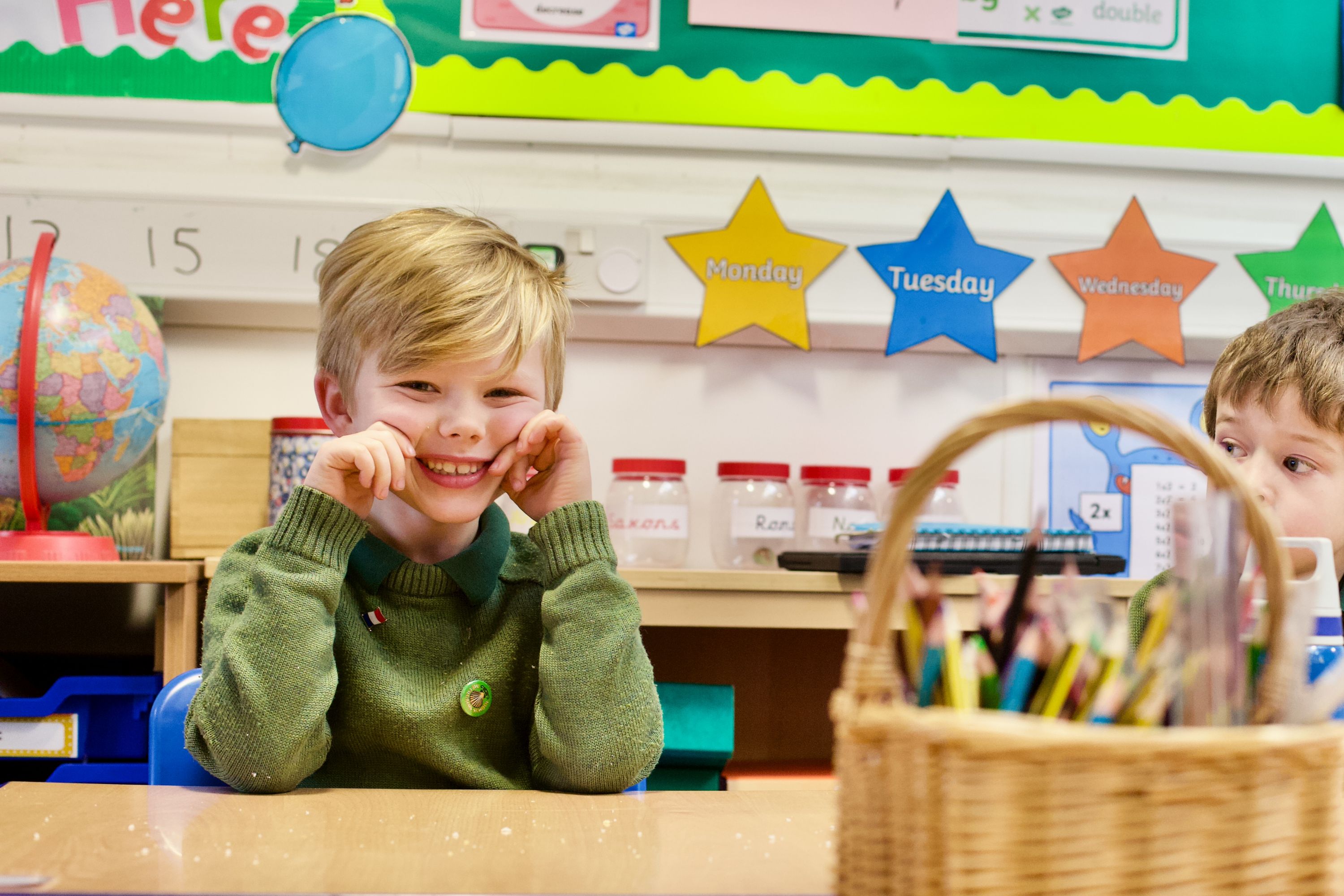 Smiling boy at desk