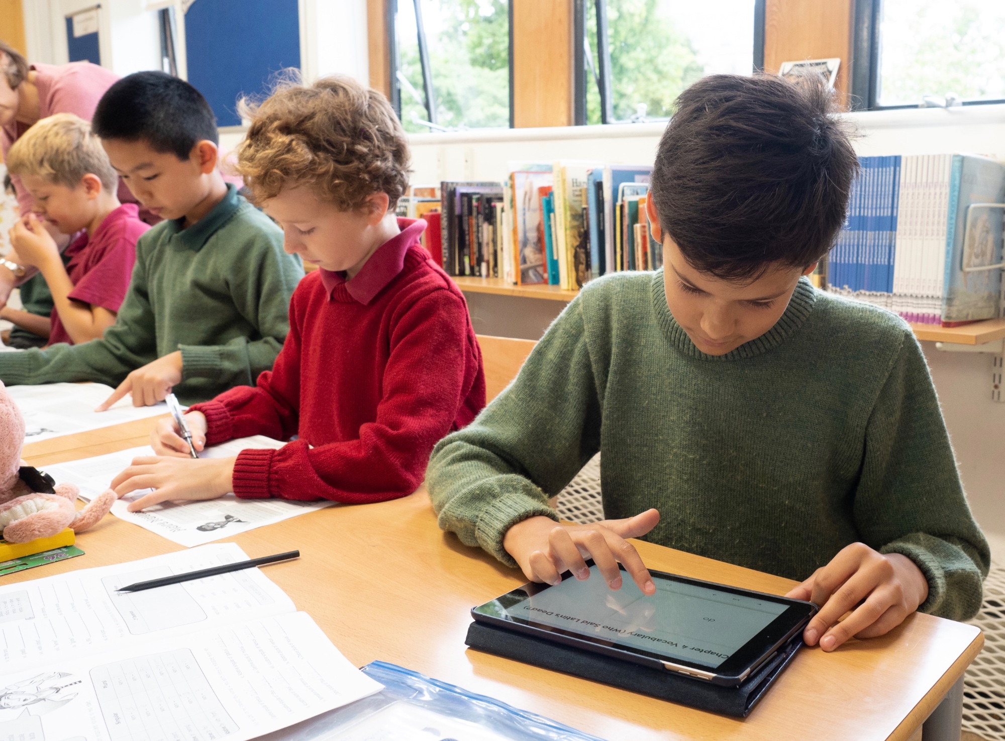 Boys in class with device