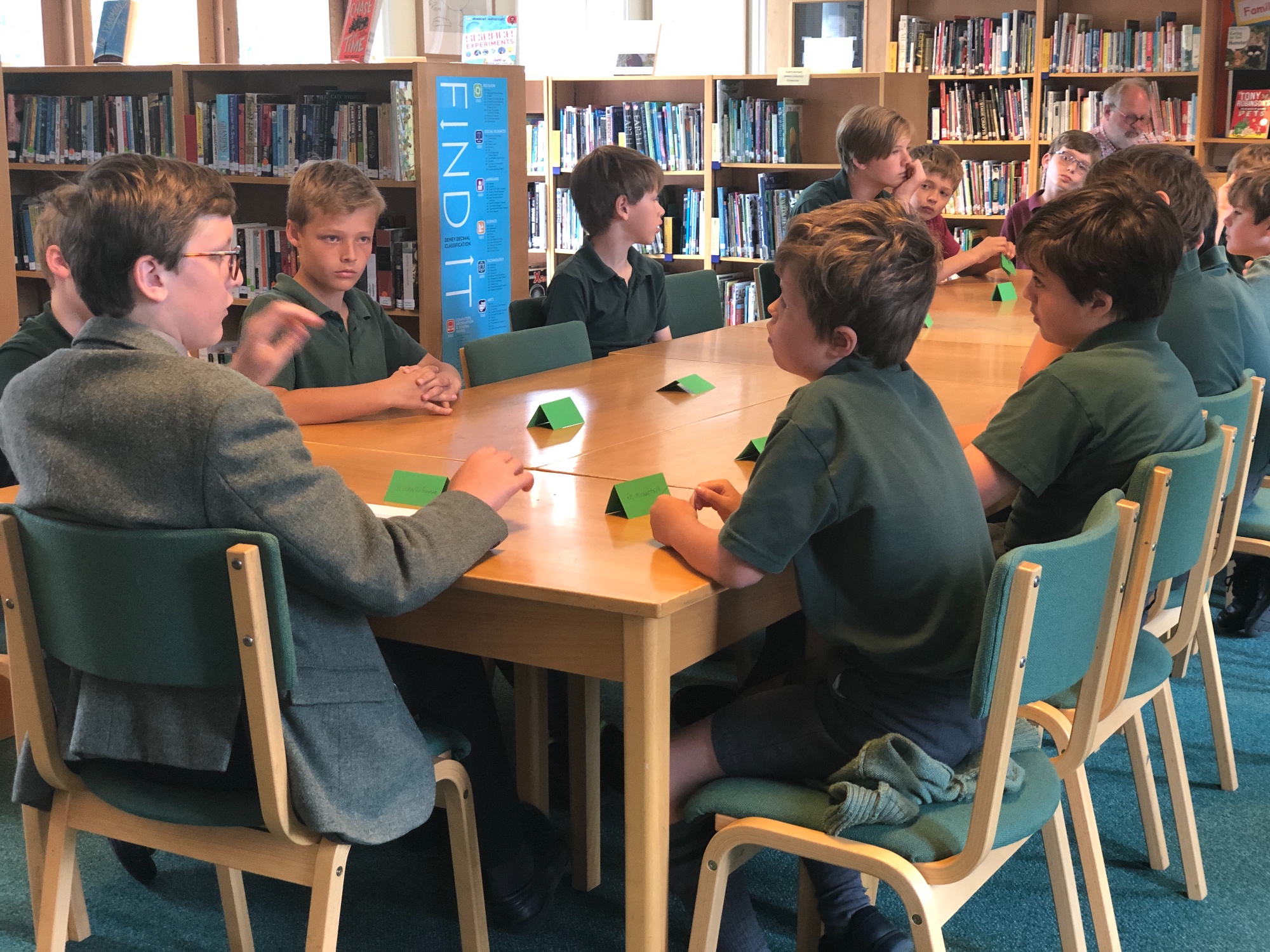 Boys round the table in the Library