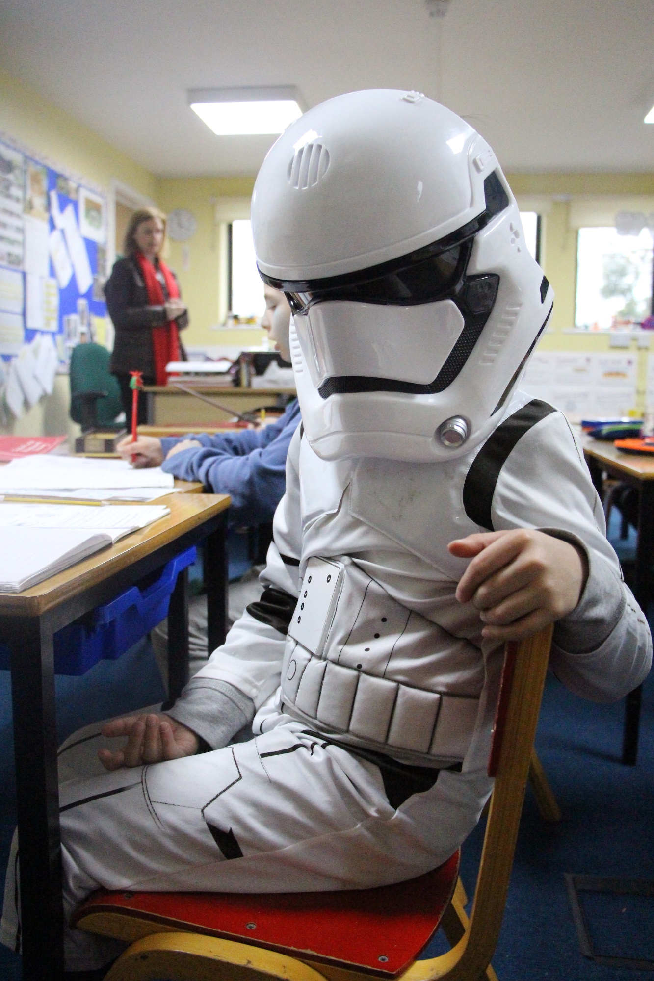 Boy dressed in suit with helmet