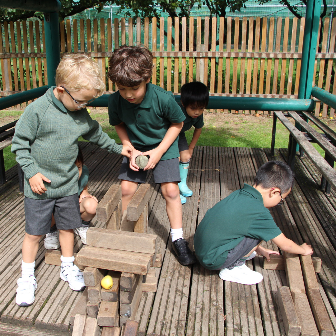 Boys playing with wooden blocks in the playground